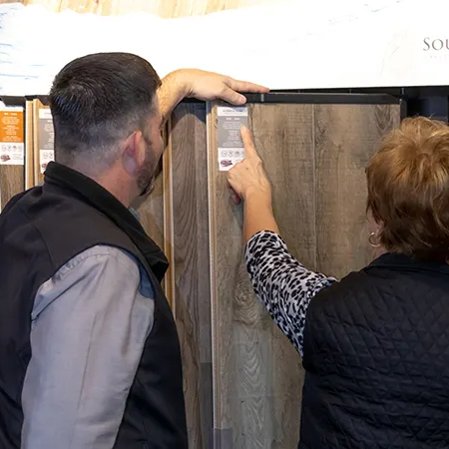 People reviewing information on wood plank samples