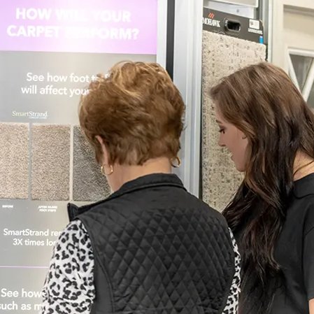People looking at carpet sample displays