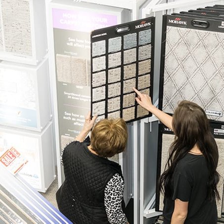 Two ladies reviewing carpet samples