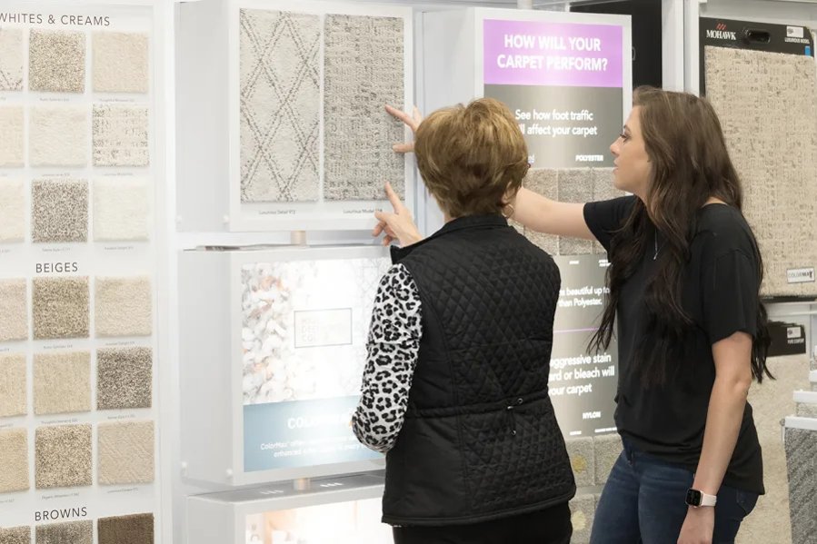 Two woman selecting carpet samples