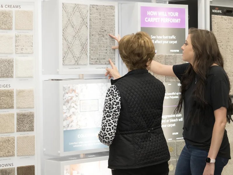 Two woman selecting carpet samples
