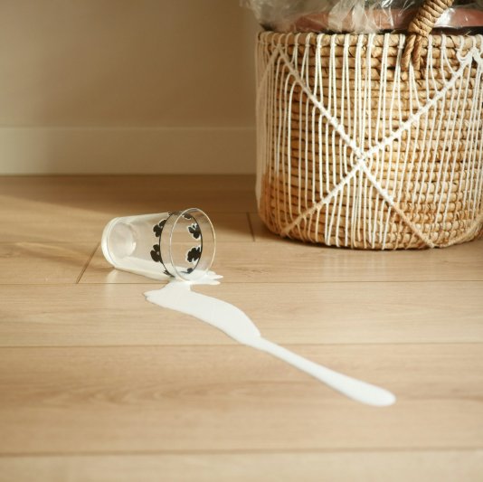 Laminate floor with a spilled glass of milk